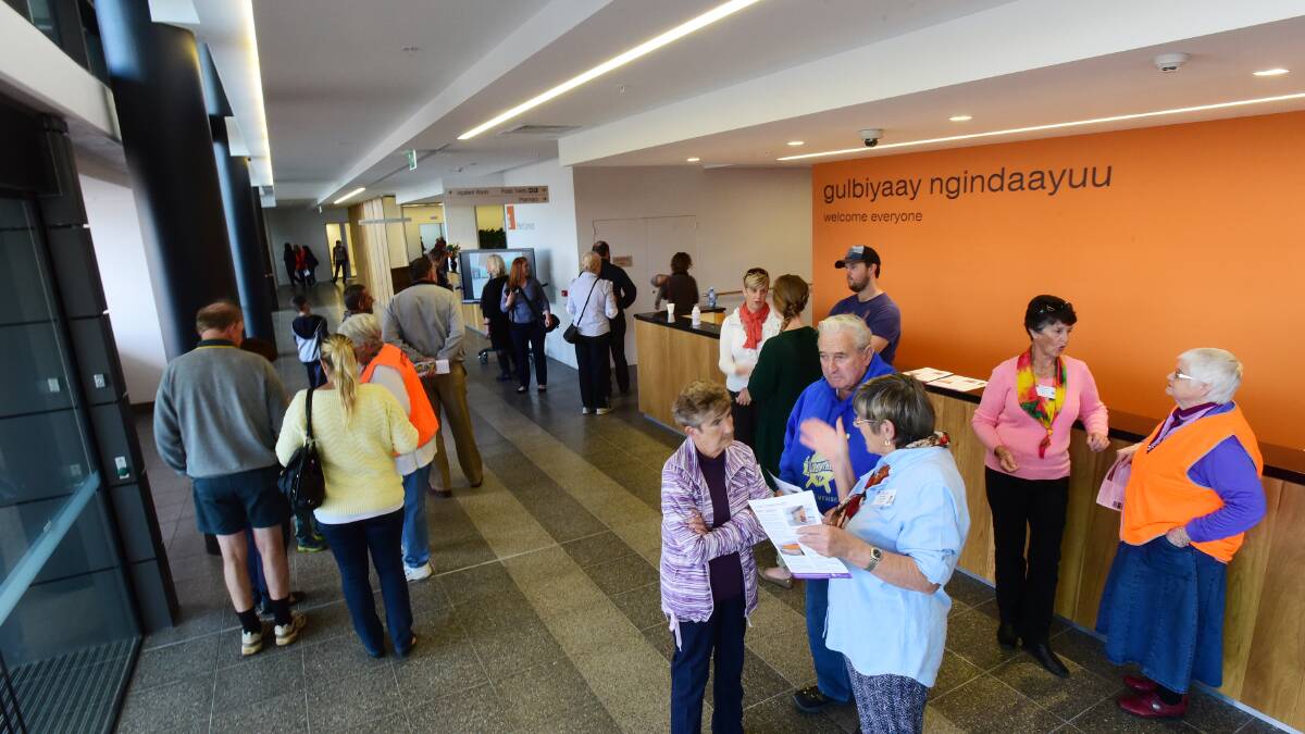 Volunteers greet locals in the foyer before taking them on tours of the facility. 130515GGB05