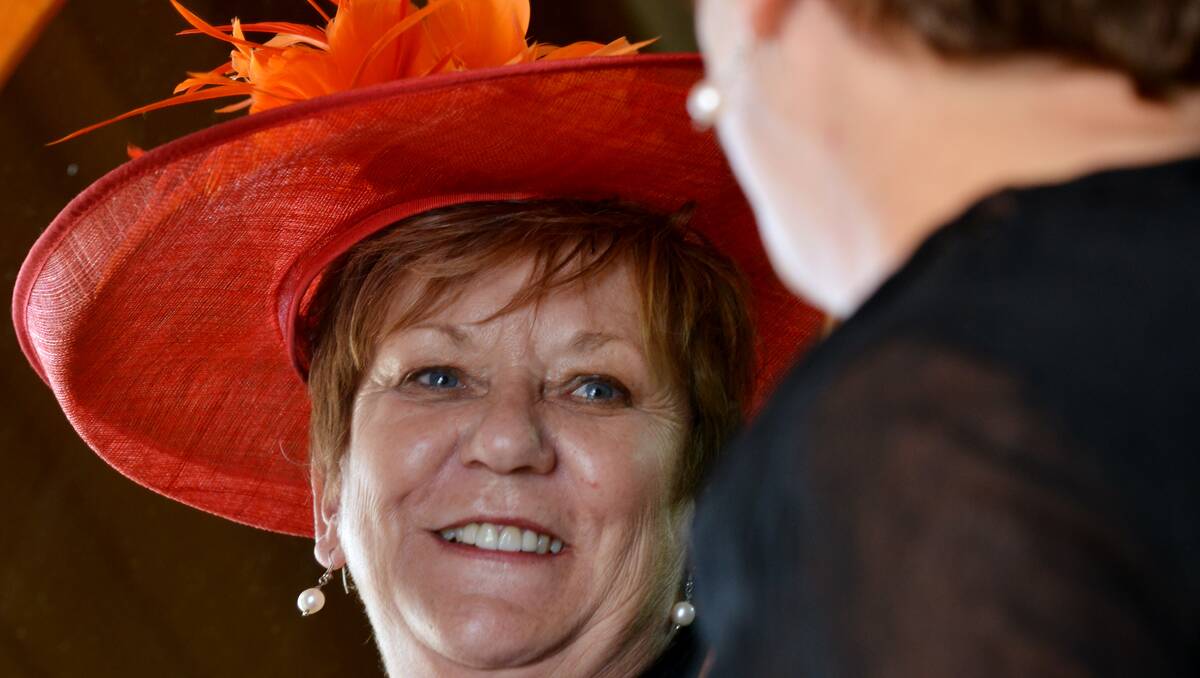 RACE-DAY READY: Helen Henry, co-owner of New Birds Boutique at Walcha, was busy earlier this week, choosing a hat for the annual Walcha Cup Races, being held today and tomorrow.  Photo: Barry Smith  060213BSH03